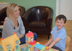 mum and son play with toys in centre