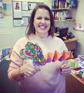 woman holds chinese paper dragon