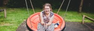 smiling girl on garden swing