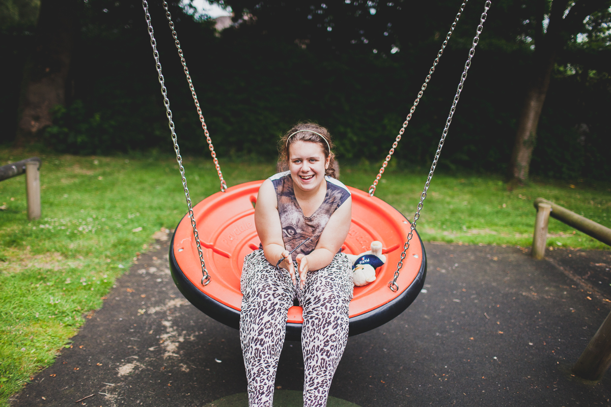 smiling girl on garden swing