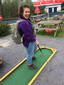 woman plays minigolf