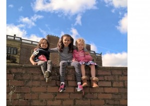 siblings climbing on wall